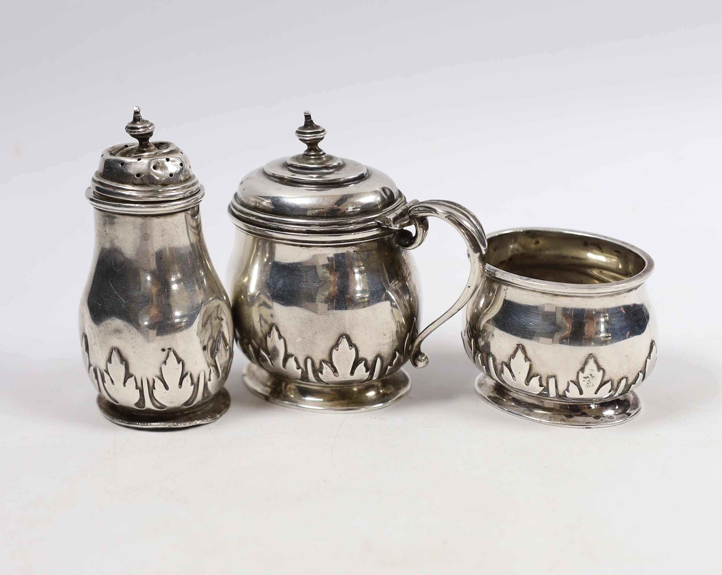 A George V silver oval three piece condiment set, Birmingham, 1913, lacking spoons.